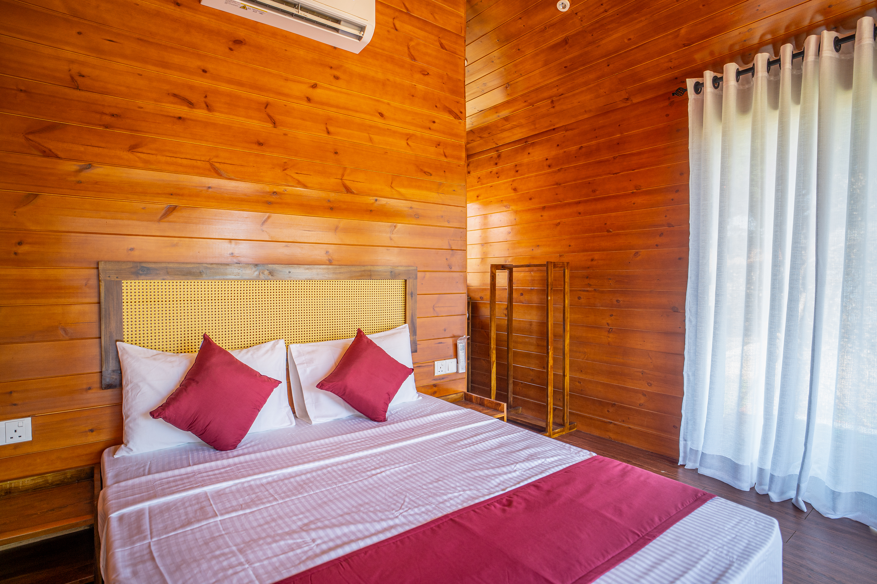 Timber-panelled bedroom with deck view
